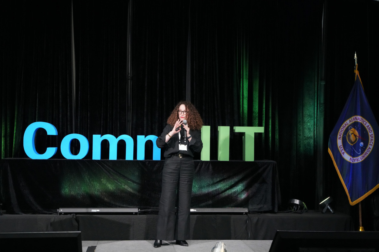 A speaker on the CommHIT25 stage