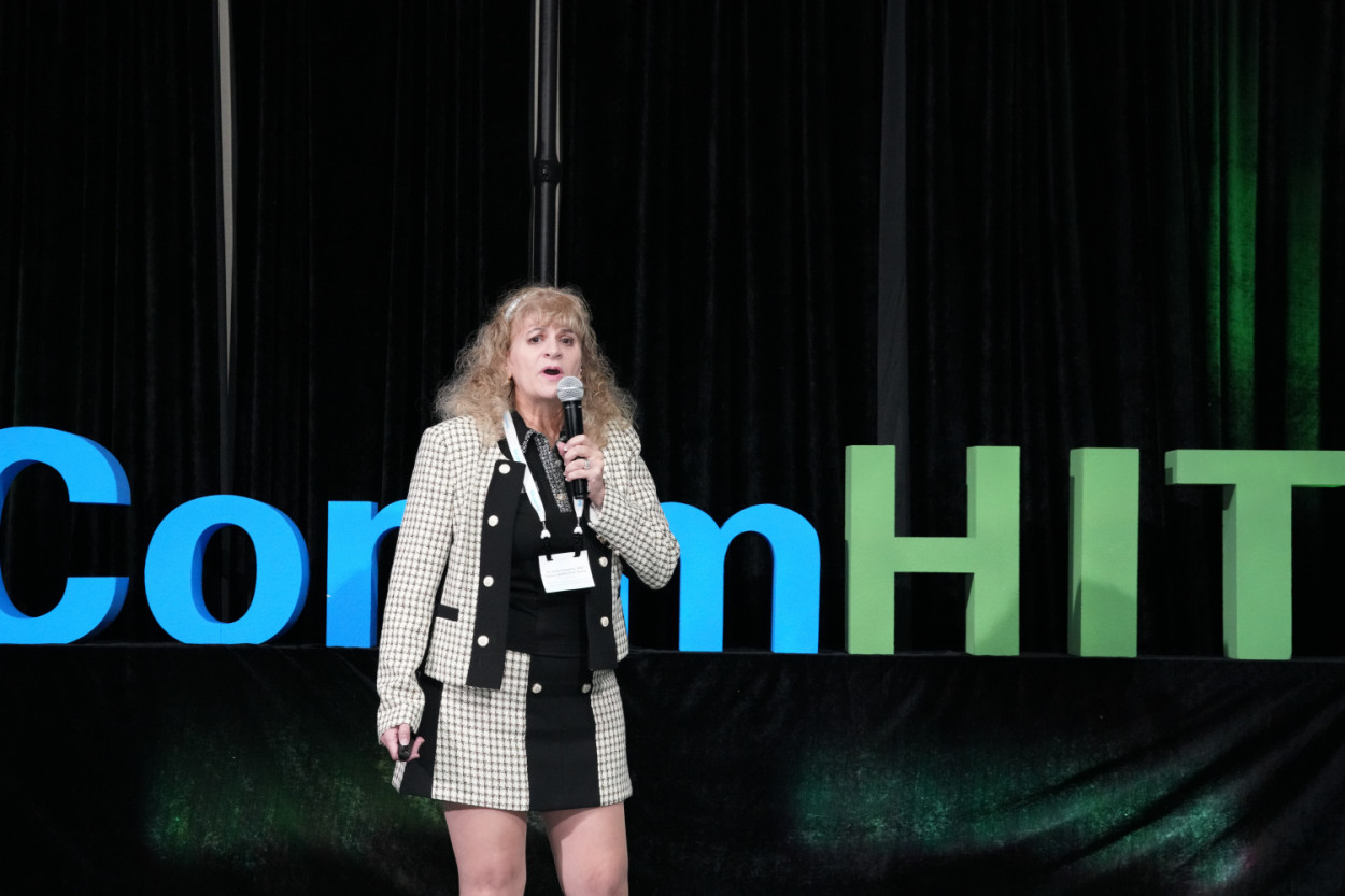 A presenter addressing the CommHIT25 audience